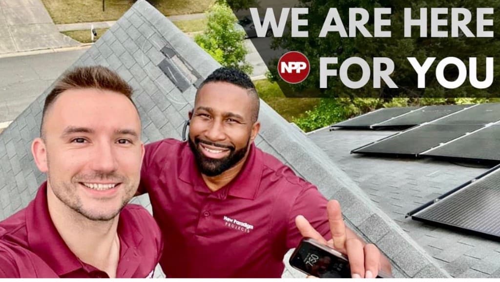 New Paradigm Projects representatives on a completed roof